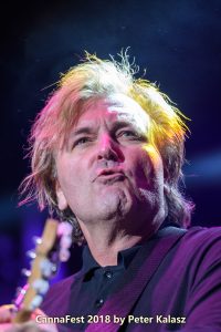 Johnnie Dee of Honeymoon Suite singing passionately during a close-up shot on stage.