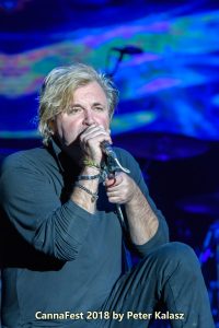 Close-up of Honeymoon Suite singer Johnnie Dee performing live and connecting with the audience.