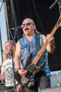 Victor Langen performing live at CannaFest 2017, rocking the stage with his bass guitar.